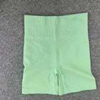 Pantalones cortos de punto acanalados para mujer, shorts de yoga sin costuras, shorts elásticos de cintura alta, shorts sexys para realzar la cadera, pantalones de tres cuartos para ciclismo y running.